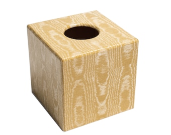 May include: A square tissue box cover with a wood grain pattern in shades of brown and white.