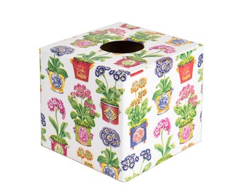 May include: Square tissue box cover with a white background and a colorful floral pattern featuring potted plants with flowers in shades of pink, purple, blue, yellow, and green.