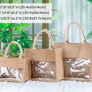 May include: Three tan jute tote bags with clear plastic windows and beige handles. Sizes: S 10x7.8x5.5 inches, M 12.2x9.8x5.5 inches, L 14.1x12.5x6.2 inches. The bags feature a rectangular structure with open tops and reinforced stitching.