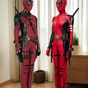 May include: Two Deadpool costumes. The costumes are red and black, with a full-body design, including a mask. One costume has a belt with a Deadpool logo, and both have a sword on the back. The costumes are displayed indoors.