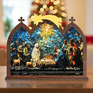 May include: A wooden nativity scene with a stained-glass effect. The scene depicts Mary, Joseph, baby Jesus, and the three wise men. The background features a star and a Christmas tree.
