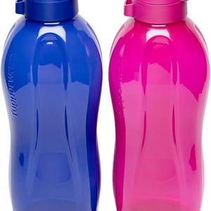 May include: Two plastic water bottles, one blue and one pink, with matching colored lids. The bottles have a curved, ergonomic design and the brand name is printed on the side. The lids have a flip-top design for easy access.