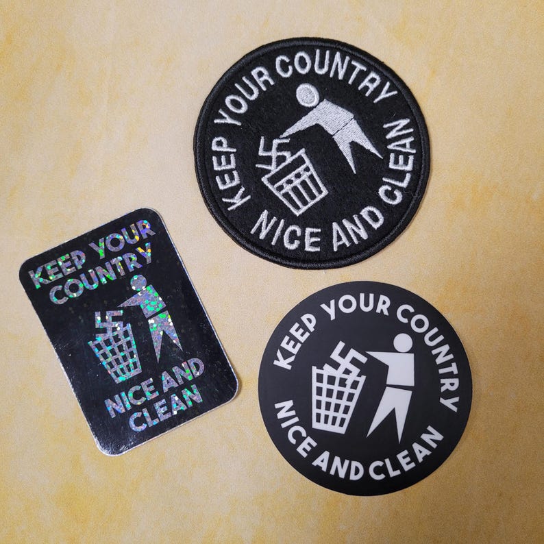 May include: Three items with the text "KEEP YOUR COUNTRY NICE AND CLEAN". One is a black patch with white text and a graphic of a person throwing a symbol into a trash can. Another is a black sticker with white text and the same graphic. The third is a holographic sticker with the same text and graphic.