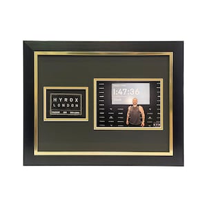 May include: Framed HYROX London finisher's display. The black frame has a gold inner border. The display includes a HYROX London patch and a photo with a finish time of 1:47:36. The display is on a white background.