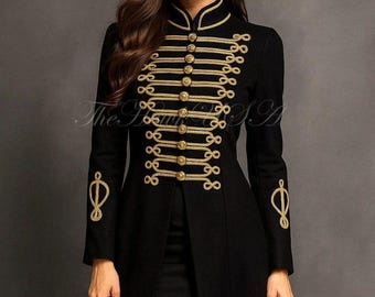 May include: Black military-style coat with gold-colored trim and buttons. The long coat features a high collar and decorative gold embroidery on the sleeves. The coat is open in the front, revealing a black skirt. The coat is a stylish fashion item.