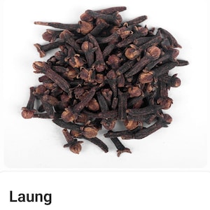 May include: A pile of dried cloves, a spice with a dark brown color. The cloves have a small, bud-like head and a long, slender stem. The image is taken against a white background.