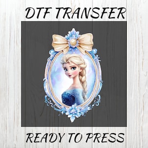 May include: DTF TRANSFER image featuring a portrait of a blonde woman in a blue dress, framed in an ornate oval with a bow and floral accents. The text "READY TO PRESS" is at the bottom, with "DTF TRANSFER" at the top.