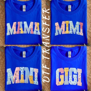 May include: Four royal blue sweatshirts with different names in a patchwork style. The names "MAMA", "MIMI", "MINI", and "GIGI" are displayed in a variety of floral and patterned fabrics. The text "DTF TRANSFER" is printed vertically on the right side.