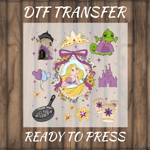 May include: DTF TRANSFER design featuring cartoon illustrations of a princess, castle, chameleon, frying pan, and other elements. The text "READY TO PRESS" is at the bottom, and "DTF TRANSFER" is at the top.