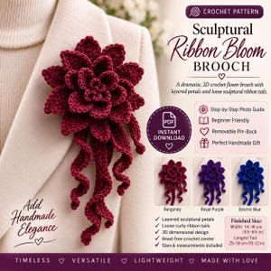 May include: A deep burgundy crochet flower brooch featuring layered petals and long, loose, curly ribbon tails. The design includes a removable pin-back. Text on the image indicates a finished width of 5.5-6.25 inches and a tail length of 10-12 inches.