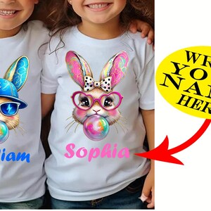 May include: White t-shirts with cartoon bunny graphics. One bunny wears a blue cap and sunglasses, the other wears pink glasses and a bow. Each bunny blows a bubble. The name "William" is printed in blue, and "Sophia" in pink.