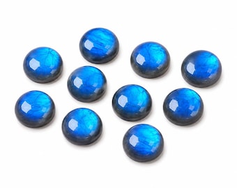May include: A collection of nine round, cabochon-cut labradorite gemstones. Each stone features a smooth, polished surface with a dark gray base and a vibrant, iridescent blue flash that reflects light across the rounded top of the gem.