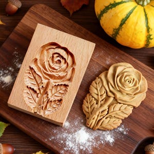 May include: A white ceramic mug with a black handle and the text "But First, Coffee" in a handwritten style. The mug is on a white surface. The mug is 10 cm tall.