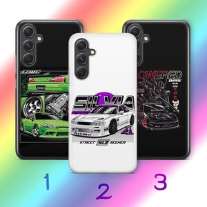 May include: Three smartphone cases featuring automotive graphics. The left case is black with green car illustrations. The center case is white with a purple and white car graphic and the text SILVIA STREET S13 SEEKER. The right case is black with a car.