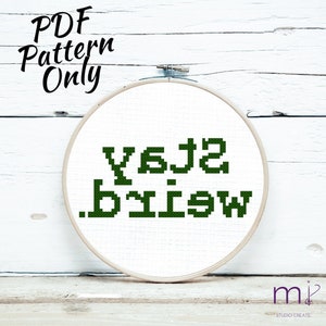 May include: A white embroidery hoop with a green cross-stitch design that reads "You are my sunshine".