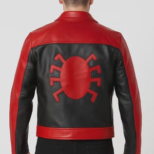 May include: Red and black leather jacket with a spider emblem on the back. The jacket features a red collar, shoulders, and lower back panel, with black on the sleeves and upper back. The zipper is visible on the sleeves.