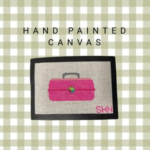 May include: Hand-painted canvas featuring a pink toolbox design with a black border. The toolbox has a gray handle and a colorful accent. The text "HAND PAINTED CANVAS" is at the top, and initials "SHN" are at the bottom right.