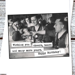 May include: A black and white photo of a group of men raising their glasses in a toast. The text reads "Wishing you cheers, beers and many more years. Happy Birthday!"
