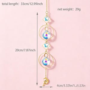 May include: A decorative suncatcher with a total length of 12.99 inches. It features a gold chain with clear crystal beads, gold rings, and a crescent moon charm. The net weight is 29 grams.
