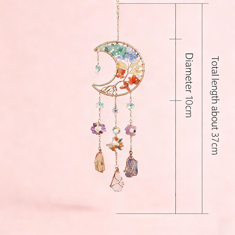 May include: A celestial-themed hanging ornament featuring a crescent moon design. The gold-colored metal frame holds colorful crystals and gemstones, with a total length of about 14.5 inches and a diameter of about 4 inches.