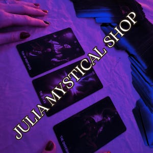 May include: Three rectangular tarot cards laid out on a surface under purple lighting. The cards are labeled Ten of Pentacles, The Star, and The Emperor. A stack of additional cards is visible to the right, and the text JULIA MYSTICAL SHOP is present.