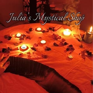 May include: An orange-red scene with lit candles, rose petals, and a deck of cards. The text "Julia's Mystical Shop" is displayed in a cursive font. Smoke rises from the scene, creating a mystical atmosphere.