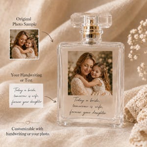 May include: A clear glass perfume bottle featuring a rectangular label with a photograph of a woman and a young girl. Below the photo, the text reads: Today a bride, tomorrow is wife, forever your daughter. The bottle has a clear rectangular cap.