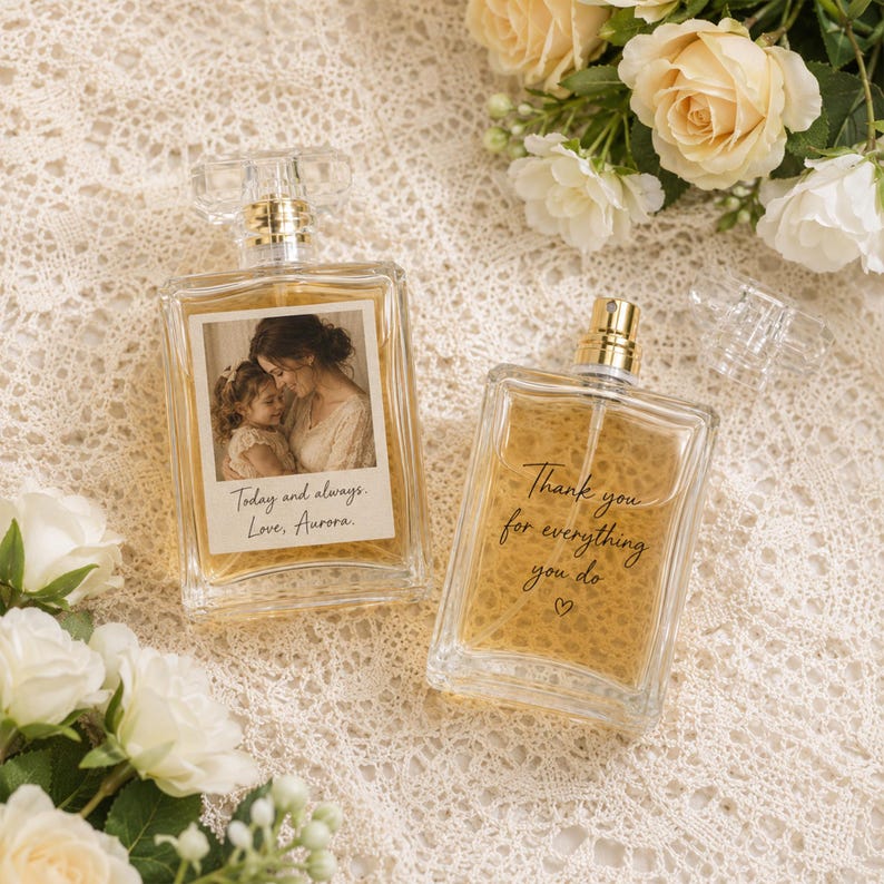 May include: Two rectangular glass perfume bottles filled with amber liquid. One bottle features a photo of a woman and child with the text "Today and always. Love, Aurora." The other bottle has the text "Thank you for everything you do" with a heart symbol.