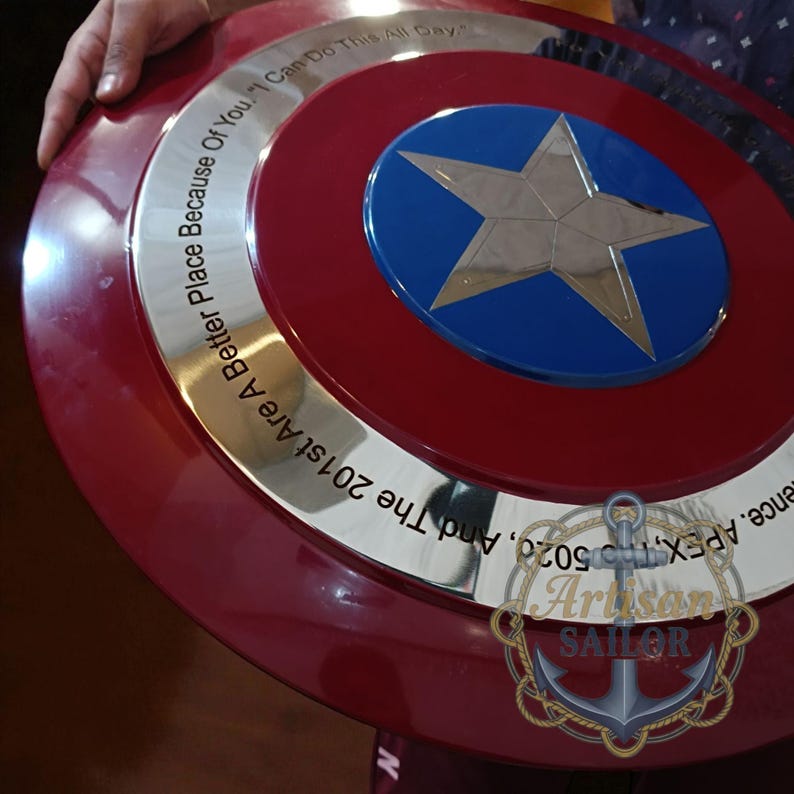 Captain America shield replica, metal wall decor with red/white/blue and star; engraved outer ring, personalized cosplay gift.