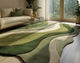 May include: A large, green, and white area rug with a wavy design. The rug features varying shades of green and off-white, creating a layered effect. The rug is placed in a living room setting with a sofa and glass coffee table.