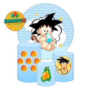 May include: A set of baby-themed party decorations featuring a cartoon character. The decorations include a large circular backdrop with a baby character, and several cylindrical stands with related graphics. The color scheme is primarily light blue and orange.