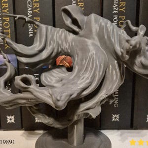 May include: A grey 3D-printed sculpture of a Dementor, a spectral creature from the Harry Potter series. The figure is posed dynamically, with flowing robes and a hooded head. The sculpture is mounted on a small base.
