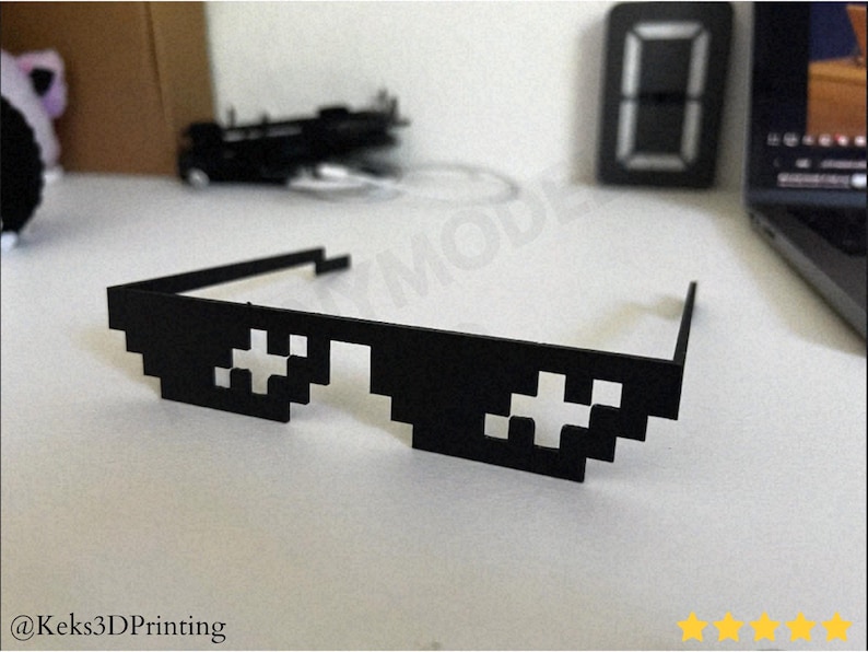 3D printable Thug Life Glasses designed as pixel meme style deal with it shades. A funny costume prop and desk accessory perfect for photos, parties, and cosplay. Lightweight and easy to wear, Blender optimized and fully compatible with BambuLab printers.