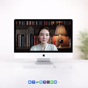 May include: A white iMac computer with a wireless keyboard and trackpad on a white desk. The screen displays a person in a video call. The background behind the person is a bookshelf and a lamp. The bottom of the screen shows several app icons.