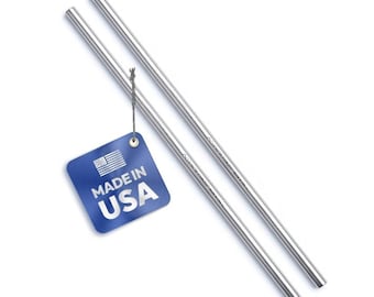 May include: Two straight, polished stainless steel drinking straws. A square blue tag is attached to one straw with a thin grey string, featuring a white American flag icon and the text "MADE IN USA" printed in bold white capital letters.