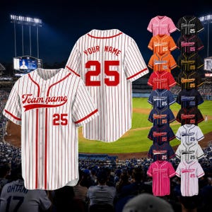 May include: A white baseball jersey with red pinstripes, red trim, and red buttons. The front displays the text Team name and the number 25. The back features the text YOUR NAME and the number 25. A column of various colored jerseys is visible.