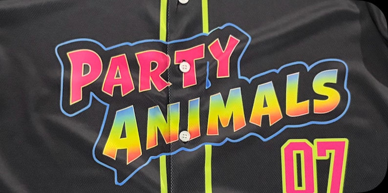 May include: A black button-down jersey featuring the text PARTY ANIMALS in a pink and rainbow gradient font with a light blue outline. The jersey includes vertical neon yellow piping, white buttons, and the number 07 in neon pink and yellow.