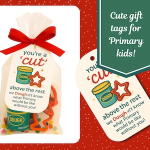 May include: A clear cellophane bag tied with a red bow, containing a small container of teal playdough, a star-shaped cookie cutter, and colorful sprinkles. The gift tag reads "you're a 'cut'" and "above the rest".