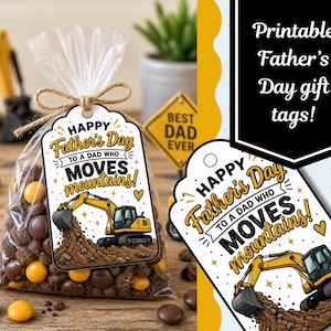 Puede incluir: Una bolsa transparente de celofán llena de caramelos de chocolate y atada con hilo de bramante, con una etiqueta de regalo que dice "¡Feliz Día del Padre a un papá que mueve montañas!". La etiqueta presenta una excavadora amarilla.