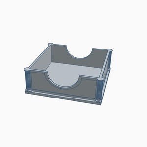 May include: A light gray, 3D-printed desk organizer with a square shape and a curved cutout on one side. The corners feature decorative vertical lines, and the overall design is minimalist.