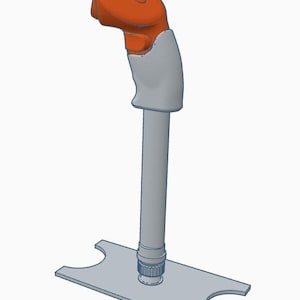 Puede incluir: Un joystick renderizado en 3D con una parte superior naranja y un mango y base grises. El joystick tiene un mango curvo y una base rectangular con recortes curvos a cada lado. El diseño es simple y moderno.