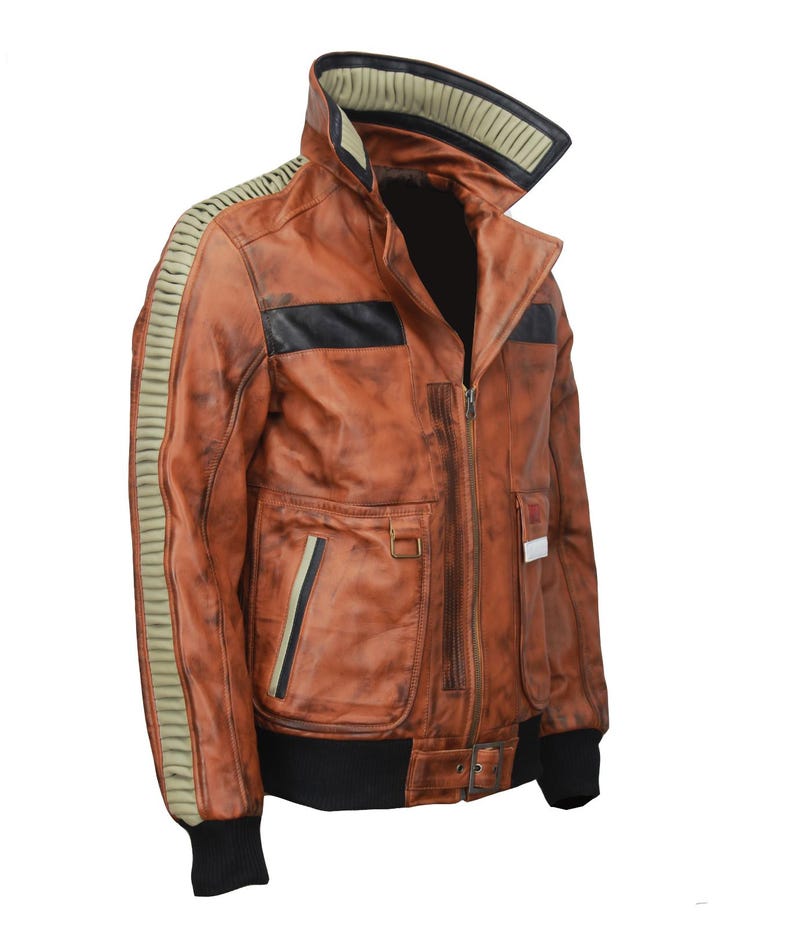 May include: A brown leather jacket with a distressed finish. The jacket features a high collar, black accents, and olive green stripes on the sleeves. It has multiple pockets and a black ribbed hem and cuffs.
