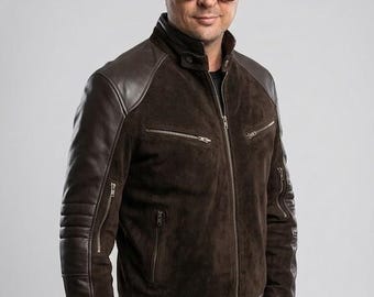 May include: A dark brown jacket featuring a suede torso and smooth leather sleeves. The jacket includes a stand-up collar, a full-length front zipper, two zippered chest pockets, two zippered side pockets, and ribbed leather detailing at the hem.