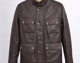 May include: A brown leather jacket with a stand-up collar and four front pockets. The jacket has a button-up closure and silver-colored buttons. The jacket is displayed on a wooden hanger against a white background.