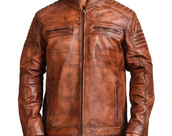 May include: A brown leather jacket featuring a stand-up collar, a full-length front zipper, and two horizontal zippered chest pockets. The shoulders and upper sleeves include quilted padding, while the waist features two additional zippered pockets.