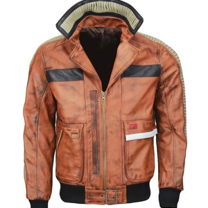 May include: A brown leather jacket with a distressed finish. The jacket features a black collar, black stripes across the chest, and multiple pockets. It has a zipper closure and a ribbed black hem and cuffs.