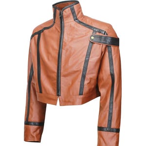 May include: A cropped brown leather jacket with black accents. The jacket features a high collar, a front zipper, and black stripes along the sleeves and shoulders. A black strap with a gold button detail is on the right shoulder.