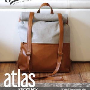 以下が含まれることがあります： 調節可能なストラップと上部ハンドルが付いた、茶色と灰色のリュックサック。 バッグにはフロントジッパーポケットがあり、前面には「atlas」の文字がプリントされています。 リュックサックの幅は35.5cm、深さは12.7cmです。