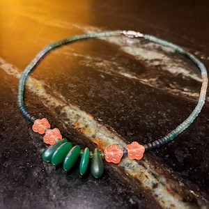 May include: A white ceramic mug with a black handle and the text "But First, Coffee" in a handwritten style. The mug is on a white surface. The mug is approximately 4 inches tall.