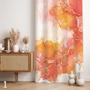 May include: A colourful curtain with an abstract design. It features flowing patterns in coral, orange, and gold, with gold metallic accents. The curtain is displayed in a room setting, adding a touch of artistic flair to the decor.